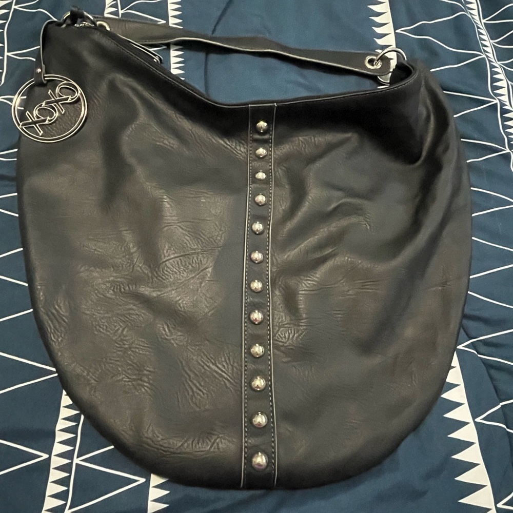 XOXO Large Hobo Bag. Black with Vertical Row of Silver Stud Accents on Front.